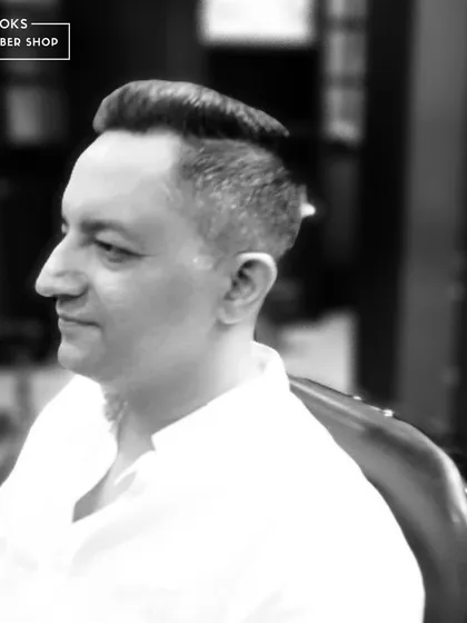 A sharp, clean haircut for one of our clients, captured in a classic black and white profile.