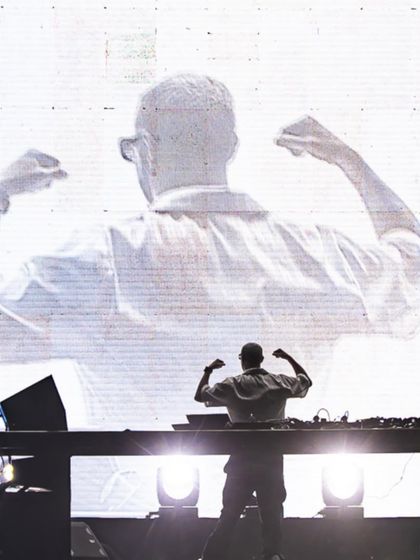 The power of a silhouette. DJ Snake's iconic pose is mirrored on the giant screen behind him, creating a larger-than-life moment during his packed arena show.