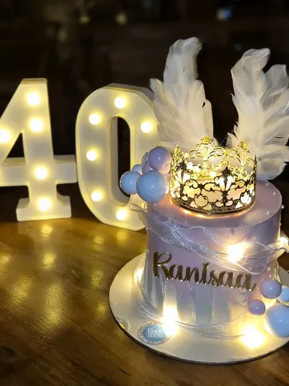 A cake fit for a queen. This 40th birthday cake features a light-up tiara, angel wings, and integrated fairy lights, creating a dreamy and ethereal glow.