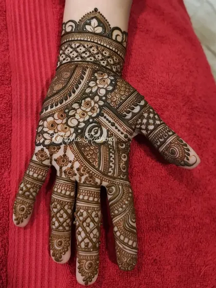 A full-palm design showcasing a beautiful blend of swirling paisleys, delicate flowers, and sharp geometric lines.