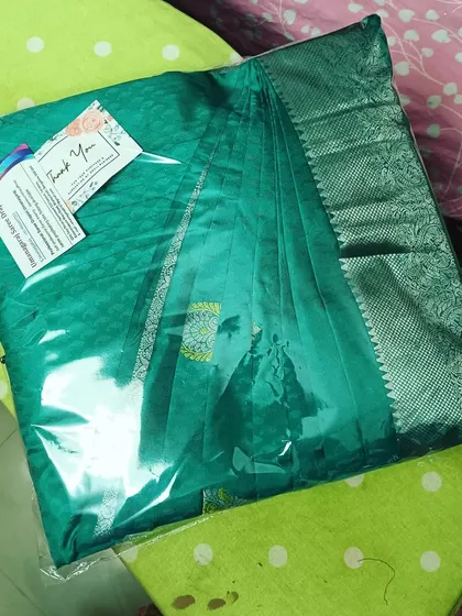 A pre-pleated and packed saree with my thank you card attached. I value every client and ensure a professional and personal touch with every order.