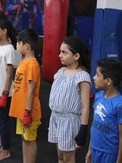 The next generation of fighters, lined up and ready to learn. I instill discipline and respect from day one, teaching them to listen, focus, and work as a team.