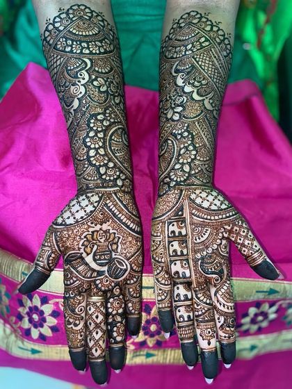 A lovely design with a mix of popular motifs, including a kalash, elephants, and intricate floral patterns.