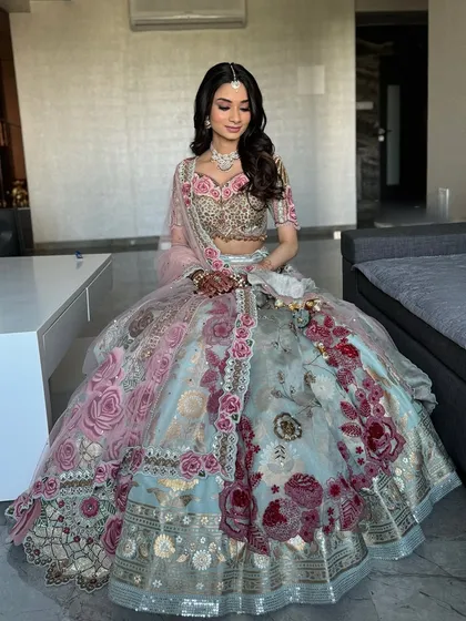 A full-length shot of Khushali's gorgeous floral lehenga. The makeup is kept soft and pretty to complement the intricate details of her outfit.