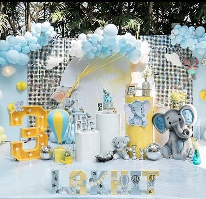 A bright and sunny day was the perfect backdrop for this baby elephant themed third birthday. The pastel color palette of blue, grey, and yellow created a soothing and adorable atmosphere that the birthday boy, Lakhit, absolutely loved.