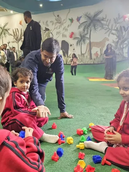 Mr. Gopichand engaging with young children at the MVN facility, showcasing our commitment to grassroots development.