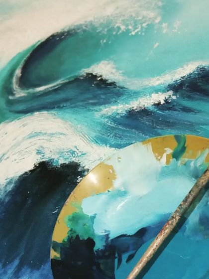 A close-up of an ocean wave painting in progress. You can see my palette with the shades of blue and white I used to capture the energy and movement of the sea. As calm as blue...