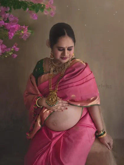 A tender moment captured as the mother-to-be looks down at her bump. The soft, painterly edit and the warm lighting enhance the emotional connection, making this a cherished memory.