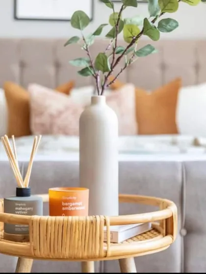 It's the small details that make a room feel complete. A simple bedside table styled with a vase of greenery, a scented candle, and a diffuser adds a personal and sensory touch to the bedroom.