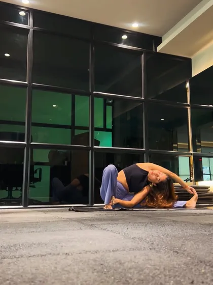 Another angle of the side-bending pose, showing the deep stretch along the side of the body. This kind of movement is crucial for maintaining a healthy, mobile spine.