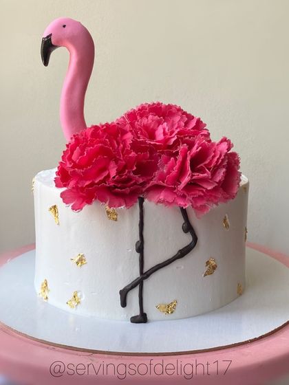 This flamingo cake is one of my favorites for its simple elegance. The bright pink flowers and handcrafted flamingo create a beautiful tropical vibe.