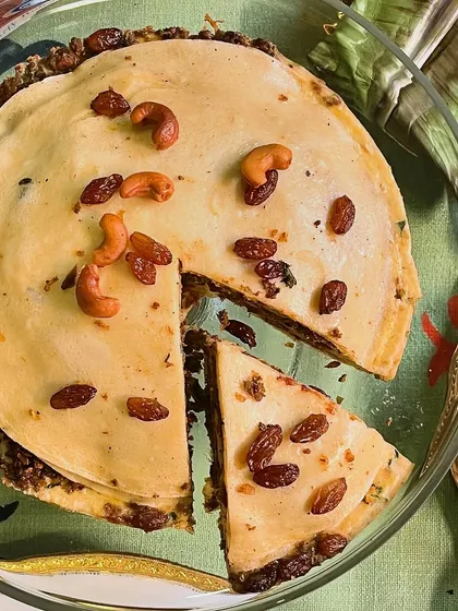 Chatti Pathiri, a Malabar-style layered pie, is a must-have for Iftar. We make it in both meaty and sweet versions, with delicate crepes layered with rich fillings, cashews, and raisins.