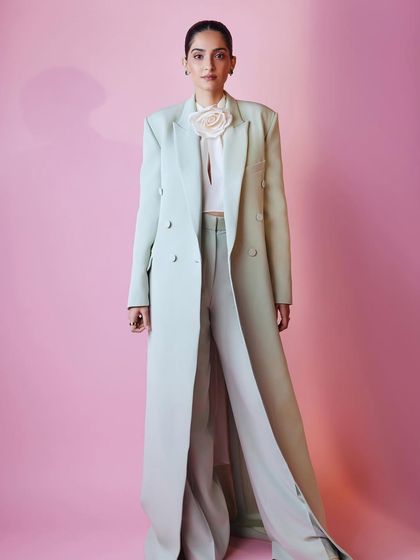 Sonam Kapoor in a powerful, full-length mint green pantsuit by Harithand, demonstrating sharp, elegant tailoring.