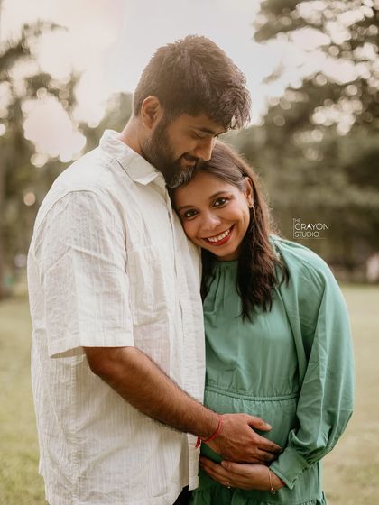 A close, intimate portrait of the couple. Her head resting on his shoulder and their gentle smiles create a feeling of comfort, safety, and deep love.