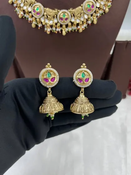 A close-up of the jhumki earrings from the antique elephant motif set.