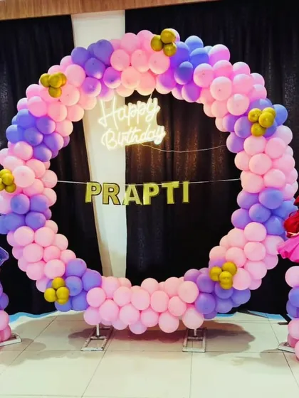 Here's a magical princess theme I created for Prapti's special day. This setup features a full circular balloon arch in pink and purple, accented with gold, and two character cutouts. I also added a custom name banner and a neon 'Happy Birthday' sign to make the photo backdrop perfect.