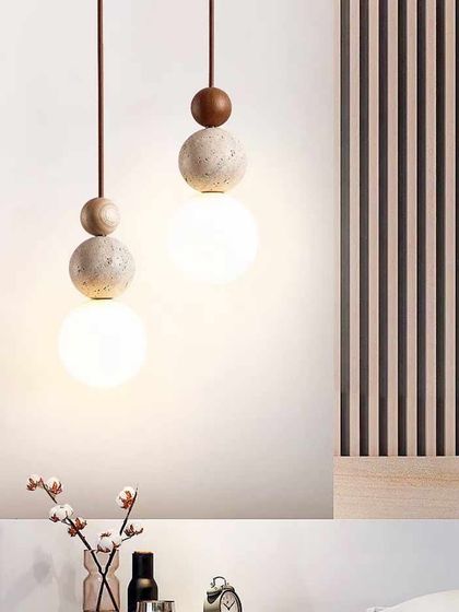 A playful pendant light combining spheres of wood, stone, and frosted glass. This fixture is perfect for adding a touch of personality to a room.