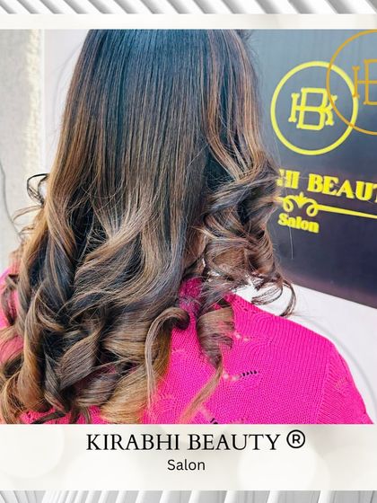 Another angle of this gorgeous hair color and style. The soft curls and caramel highlights create a warm and inviting look.