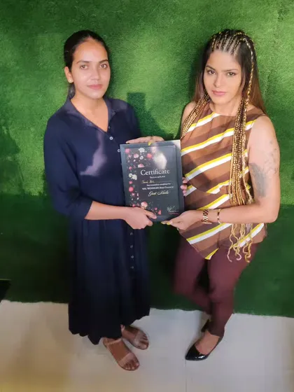 There is no greater reward than seeing my students achieve their goals. Here, I am presenting a certificate of completion, marking the moment a dedicated student becomes a qualified nail professional, ready to start her own career.