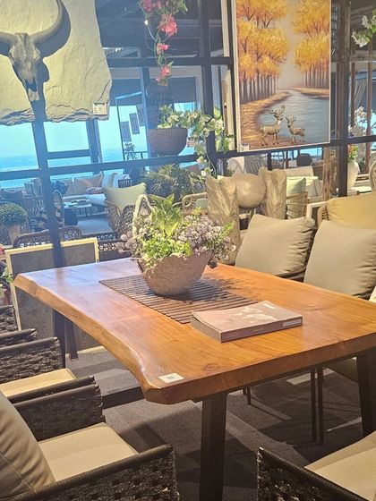 A view of our 16,000 sq. ft. showroom, the largest collection of outdoor furniture in East India. This dining set features a live-edge wooden table, perfect for a rustic-chic terrace.