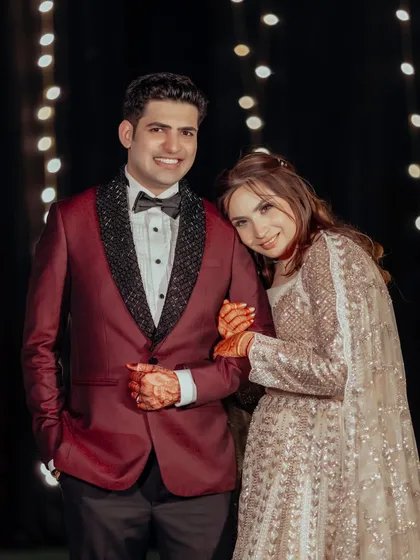 Lokesh and Kritika share a tender moment at their ring ceremony. The warm lighting and her gentle lean on his shoulder create a feeling of comfort and love.