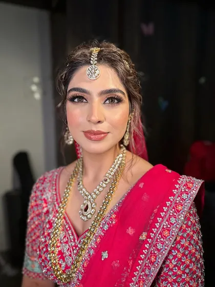 Jasleen looking absolutely stunning and confident on her special day, with makeup that enhances her natural beauty.