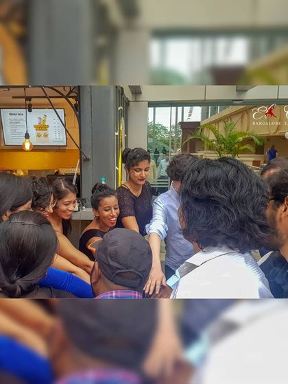 A team huddle before our flash mob. This moment of unity and excitement shows the strong sense of community and shared purpose among our dancers.