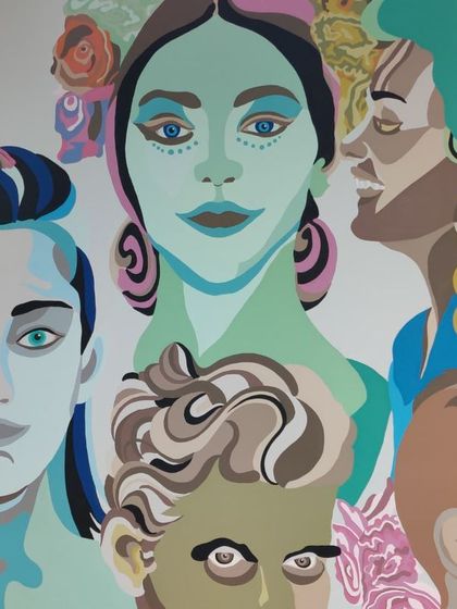 A detailed shot of the diverse faces in the 'I choose to be happy' mural.