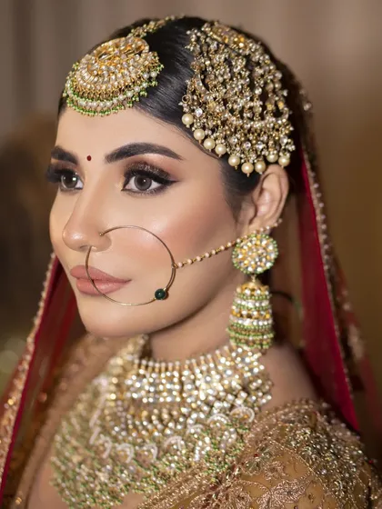 A close-up of my Heritage Bride look. I focused on creating sharp, defined features with bold winged eyeliner and a matte nude lip, letting the magnificent Polki and pearl jewellery shine. This is for the bride who wants to look like pure royalty.