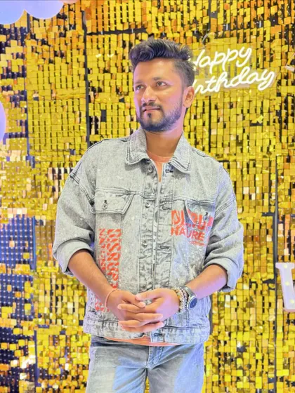 Posing against a beautiful golden sequin backdrop at a first birthday party I hosted in Kharghar.