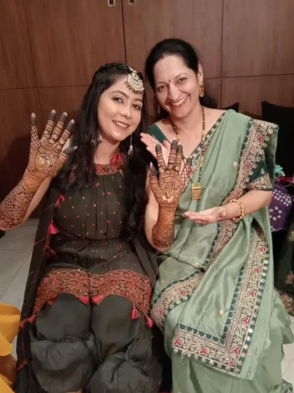 A happy moment from the mehendi ceremony, with the bride and her mother showing off their henna. It's always a joy to see the whole family celebrating together.