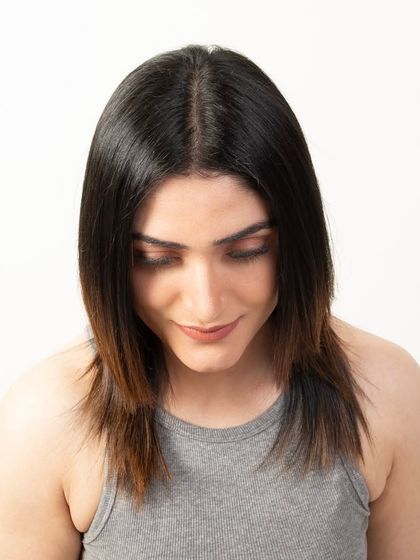 A top-down view of the model's hair with the topper applied, proving its seamless integration and natural appearance.