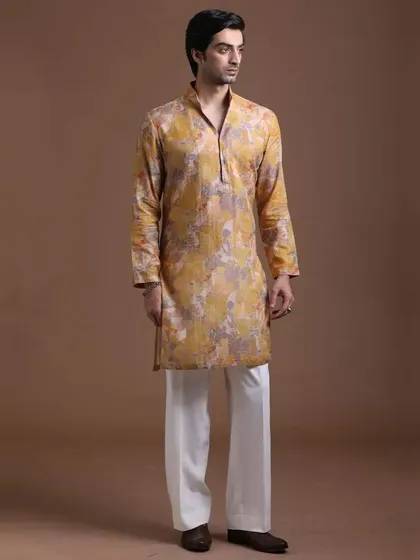 A unique printed yellow kurta with abstract patterns. This is for the man who wants a traditional silhouette with a contemporary, artistic touch.