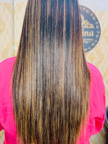 A beautiful example of balayage highlights on long hair. I used a blend of caramel and blonde tones to create a natural, sun-kissed effect that adds dimension without being high maintenance. The hair is also straightened to show the sleek finish.