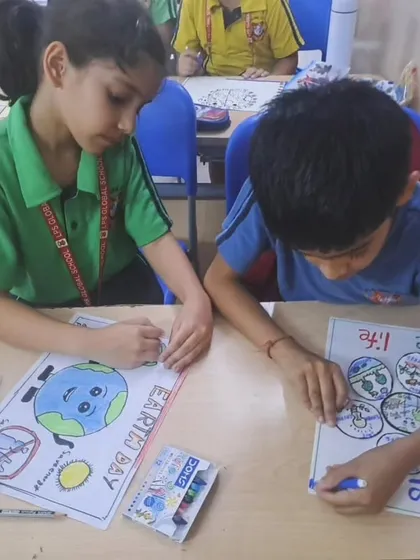 Two students collaborate on their posters, sharing ideas and art supplies, demonstrating the spirit of teamwork for a common cause.
