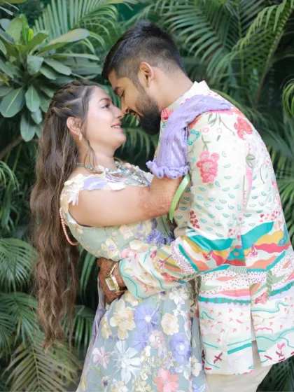 A happy, candid moment of the couple. The bride-to-be's makeup is fresh and radiant, perfect for a daytime celebration.