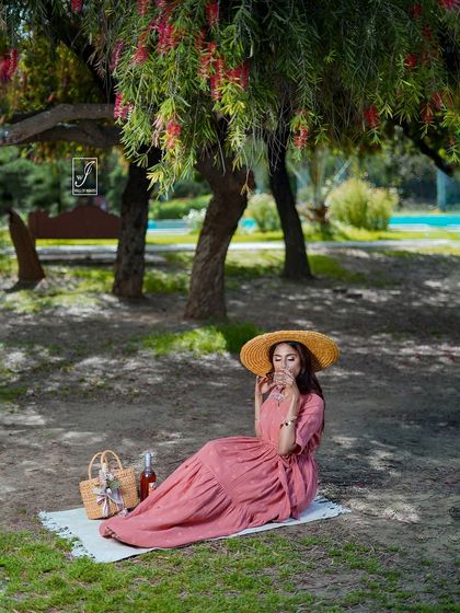 A wider shot of the picnic setup, establishing the peaceful and idyllic atmosphere of the entire fashion story.