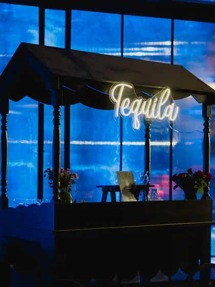 A chic tequila bar with a custom neon sign, adding a fun and modern touch to the evening's festivities.