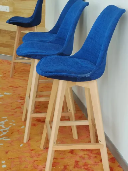 Our high counter chairs with natural beech wood legs and a comfortable blue fabric seat. This is a simple, sturdy design perfect for cafes or homes.