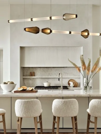 The Luna Kaleido series in a bright, modern kitchen. The linear form is ideal for illuminating a long island, while the glass elements add a touch of color and texture.