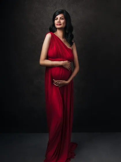A more formal, full-length pose in the same stunning red gown. This portrait is the epitome of elegance and grace.