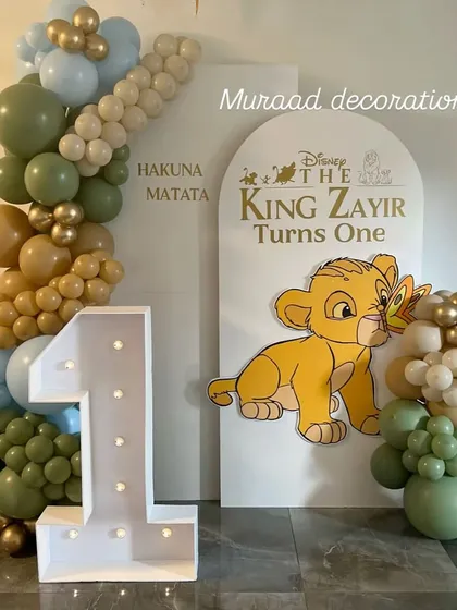 For this first birthday, we brought the world of The Lion King to life. The setup features a custom "Hakuna Matata" backdrop, a light-up marquee number '1', and a cute Simba cutout, creating a perfect photo spot for the little one.