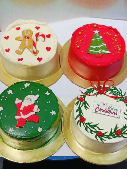 A collection of mini Christmas-themed cakes. These are perfect for small gatherings or as individual holiday treats.