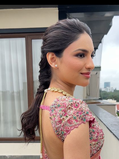 A side profile of a bride with a modern, textured fishtail braid, showing how it elegantly frames her face.