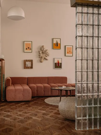 This image captures a collection of our unique seating and table designs. From a plush, channel-tufted sofa to a sculptural lounge chair made of upholstered stone, each piece is designed to be a work of art.