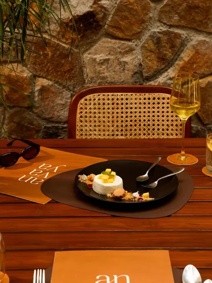 A delicate panna cotta dessert with fresh mango, enjoyed with a glass of white wine during a winter brunch.