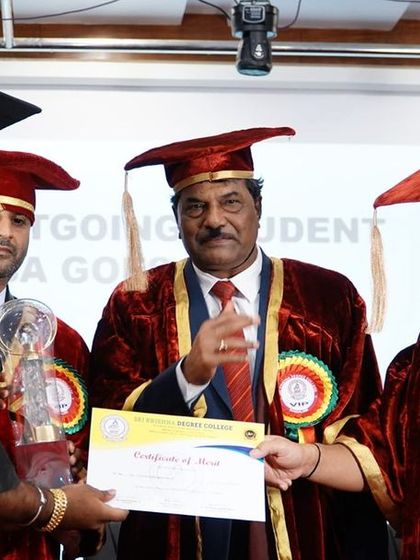 Awarding a trophy to an outstanding student. Recognizing excellence motivates others to strive for greatness.