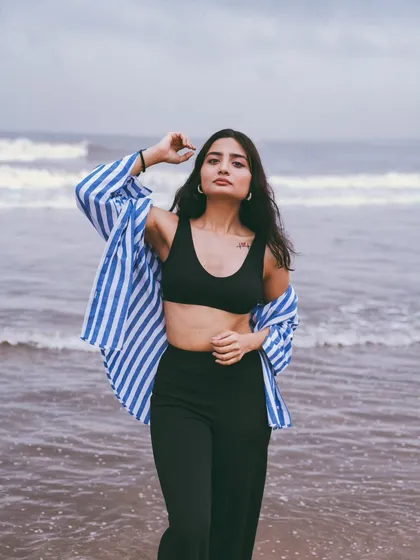 Even on an overcast day, the beach has a unique mood. This portrait captures a strong, confident look against the dramatic, churning waves.