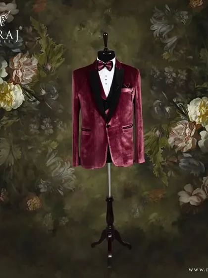 For the groom who commands attention, I designed this striking three-piece tuxedo. The rich red velvet jacket, paired with a classic black satin lapel and bow tie, offers a bold and sophisticated look for a reception or formal event.