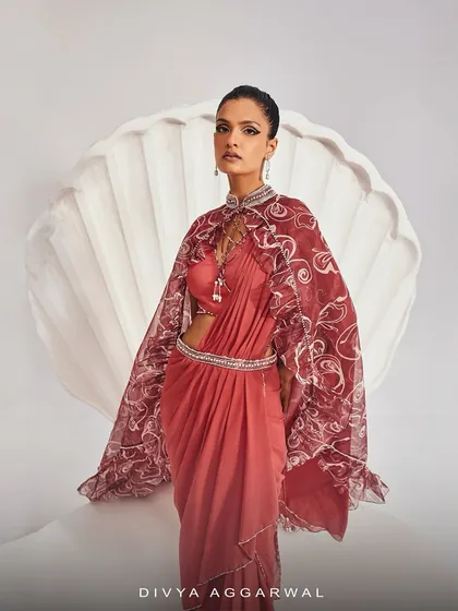 The Serena Saree Set, basking in distinctive silhouettes for a palatial finesse. The printed ruffle cape with its embellished collar is the centerpiece of this regal look.
